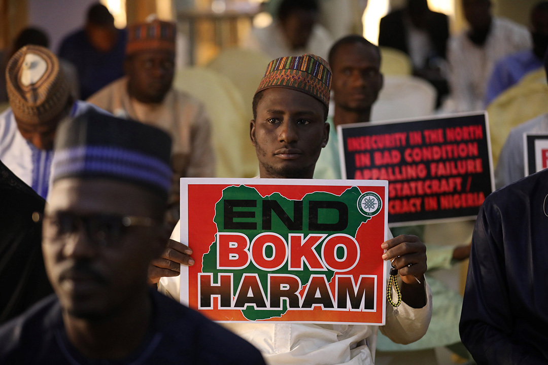 A man holds up a sign that says "End Boko Haram"