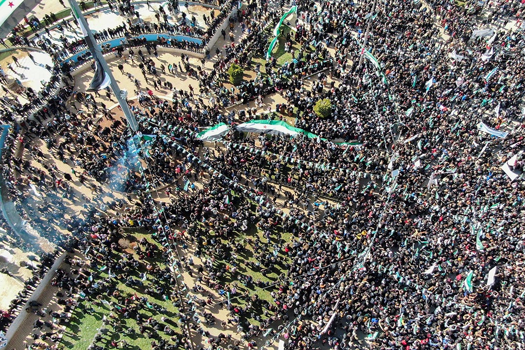 Aerial photo of a large gathering of people in a park.