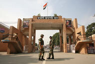 Indian border security force soldiers prtrol in front of Wagah border gate.