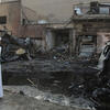 A man inspects the site a day after a bomb attack in Baghdad.