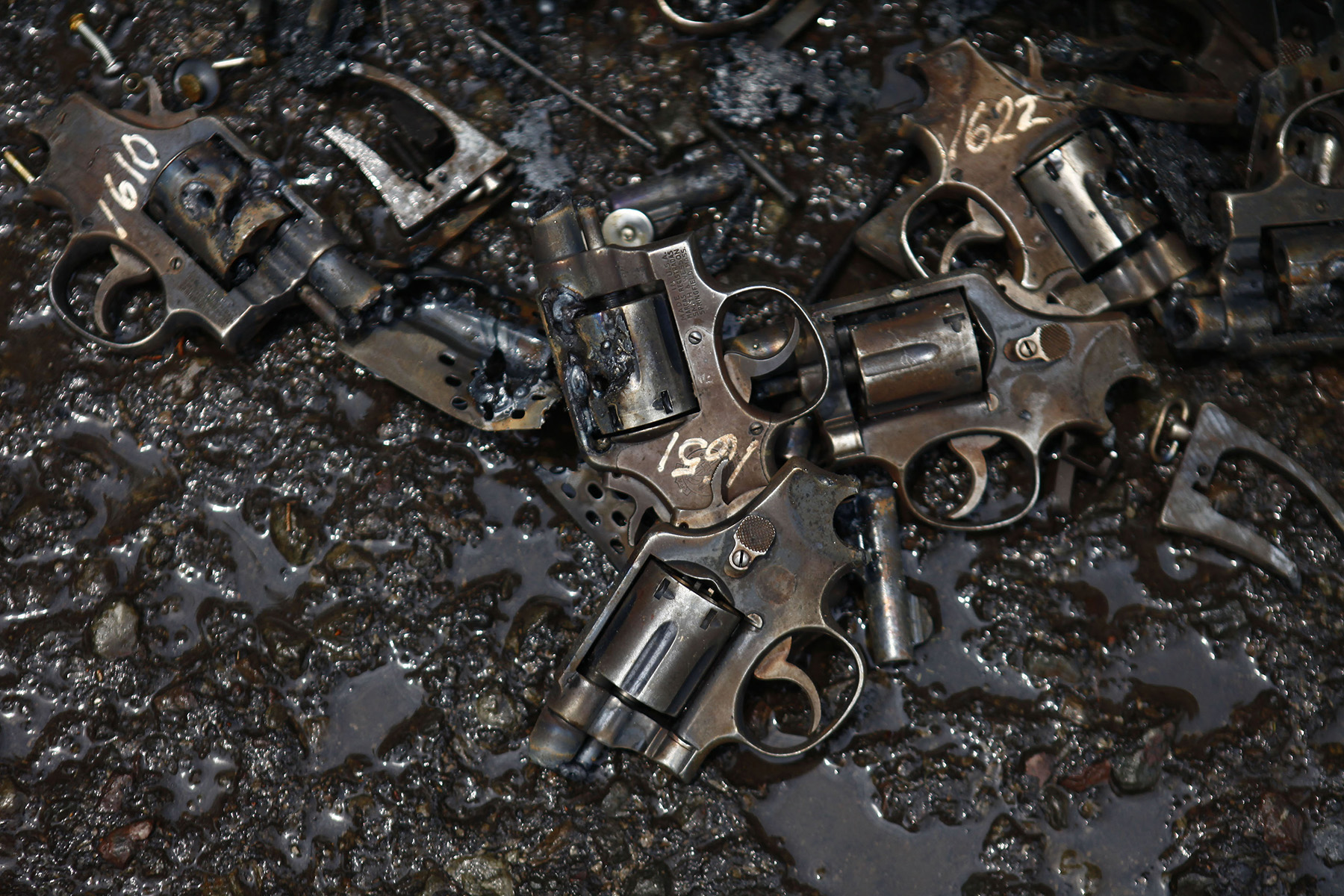 Parts of confiscated weapons by national security authorities are seen on a floor after they were destroyed at a military zone of Mexico City .