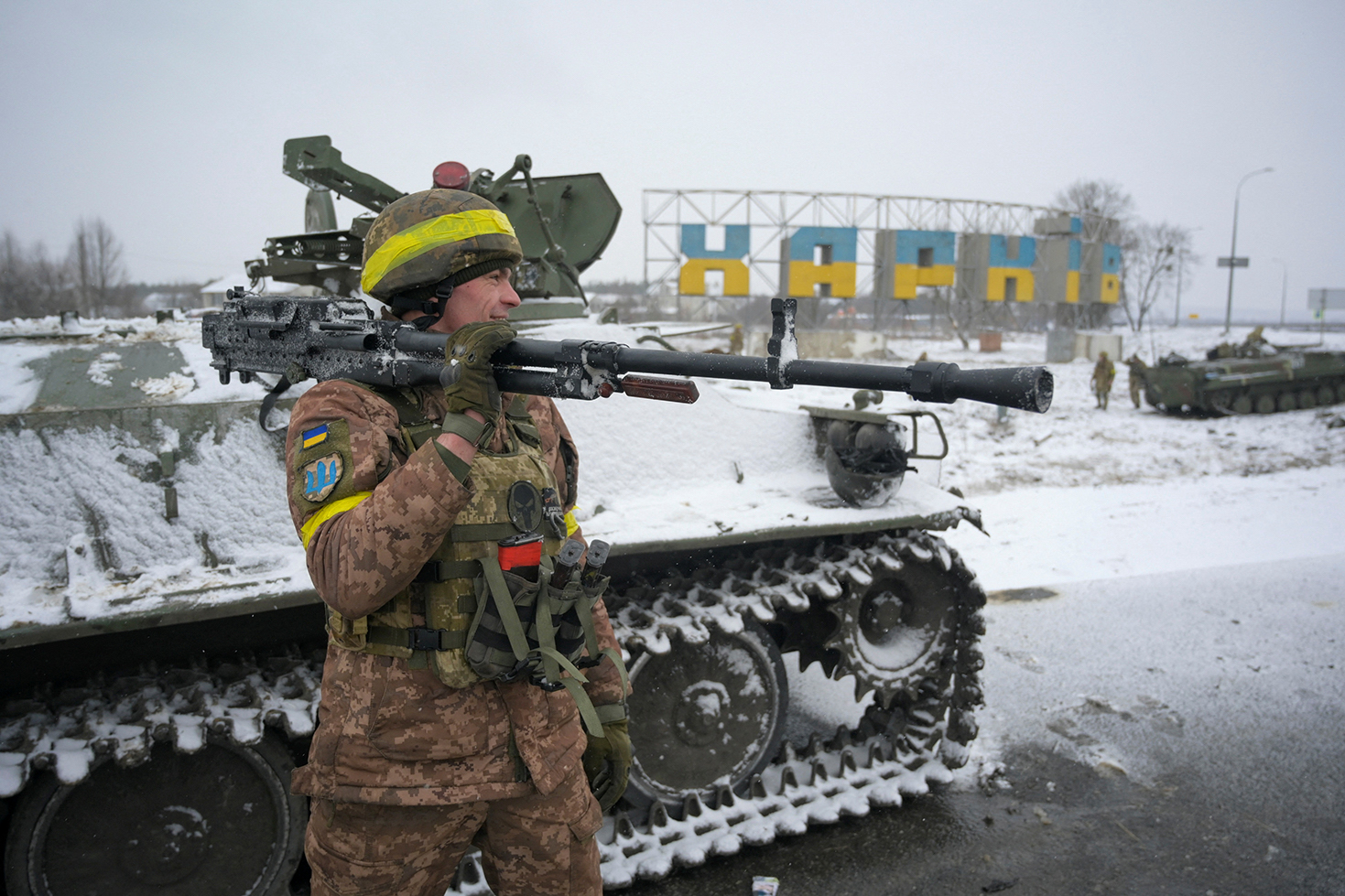 A Ukrainian serviceman reacts while holding a weapon in Kharkiv, Ukraine, on February 25, 2022. 